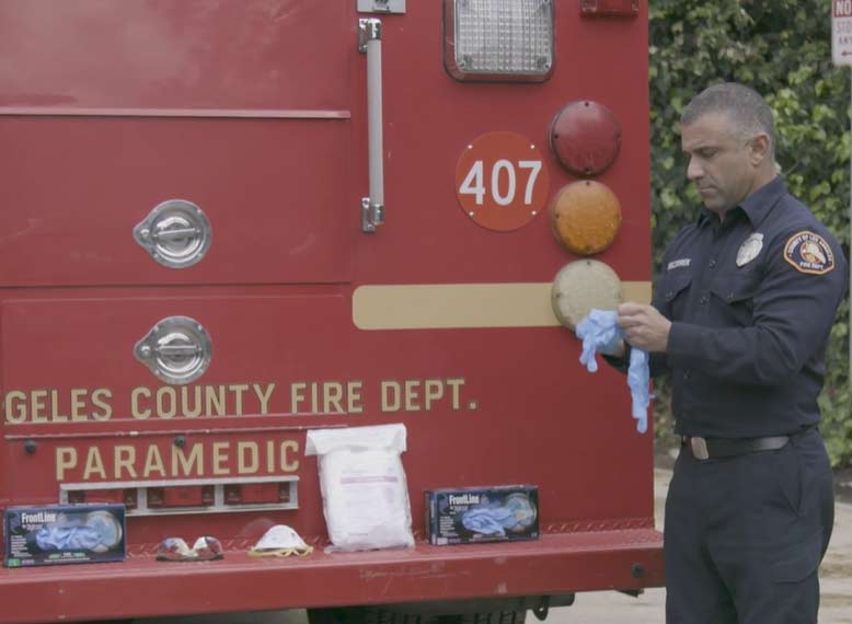 Los Angeles County medic donning gloves