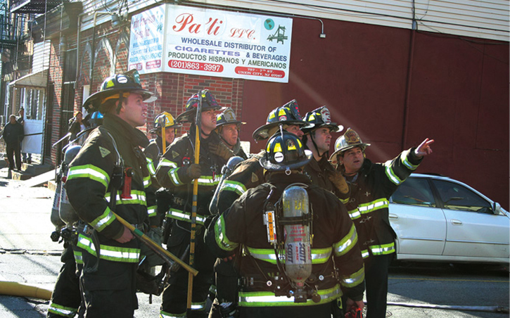 Command assigns a company in tactical reserve to a fireground task. If this team was originally assigned the RAT duty, another team would be assigned by policy to replace it immediately. Here, the team standing by in the rear can now be assigned as the RAT. It would acknowledge the RAT assignment over the radio.