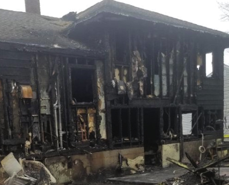 The fire caused the collapse of a three-season room (bottom, right) along with heavy charring up to ½-inch thick. Additionally, the intensity of the fire can be seen as it burned through multiple 1 × 6 planks of sheathing, exposing interior gypsum board and plumbing.