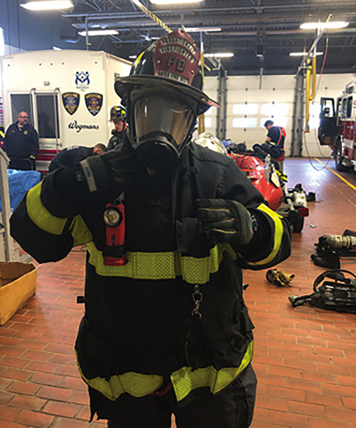 A firefighter with full PPE in zero visibility.