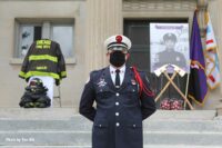 A photo of Araujo, ceremonial axs, and his turnout gear