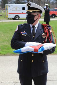 Firefighter bearing a flag