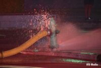 Fire hydrant with supply line spraying water