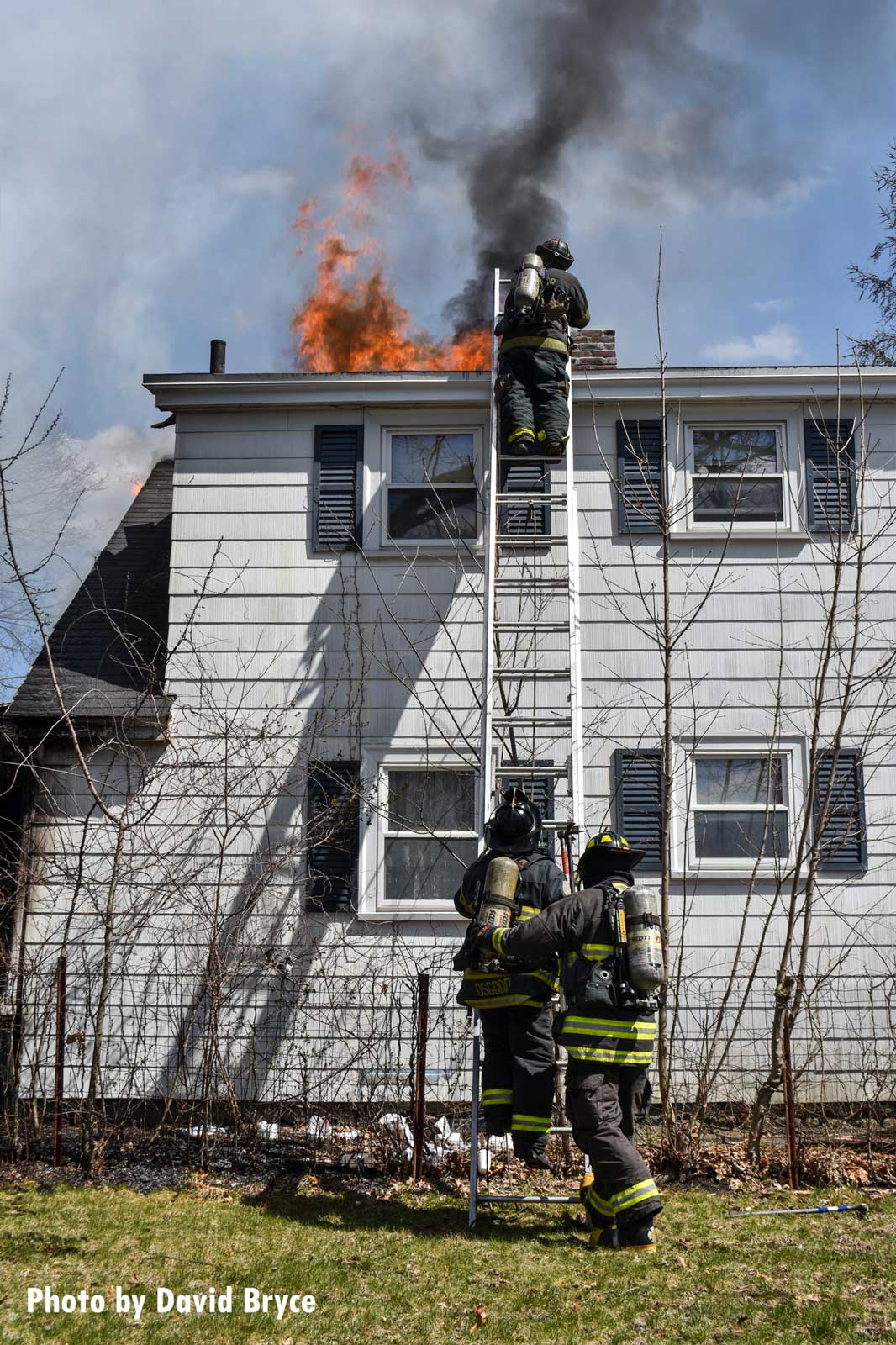 Firefighters perform vertical ventilation at a fire in Fitchburg, Massachusetts