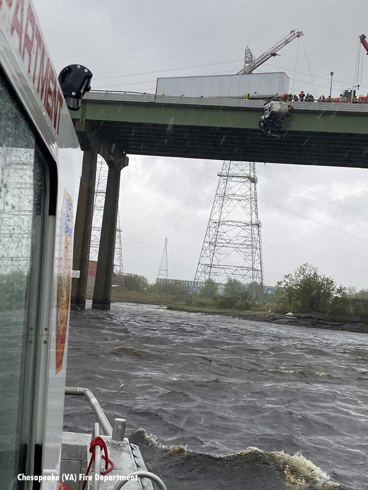 A view from a fireboat of the cab dangling off the bridge