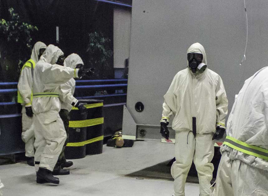 Hazmat team members in hazmat suits