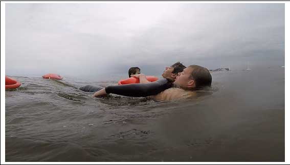 A surf rescue technician uses the cross-chest-carry with a Burnside RFD