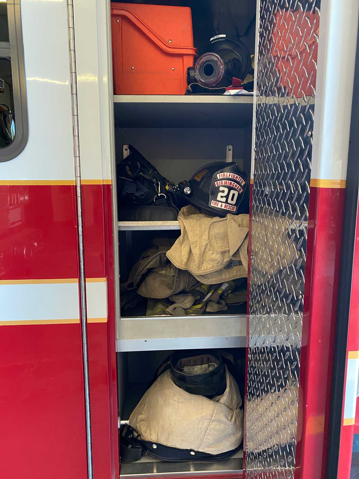 A compartment on a fire apparatus containing firefighting gear