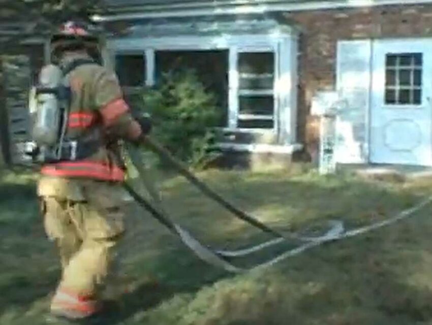 Firefighter flaking out a hoseline