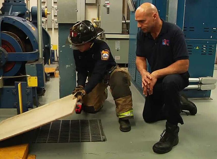 Mike Dragonetti and another firefighter in the elevator machine room