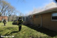 Fire is seen starting to emerge from the roof of the home