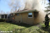 Another view of smoke and flames from the roof of the home