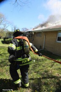 A firefighter flakes out a hoseline