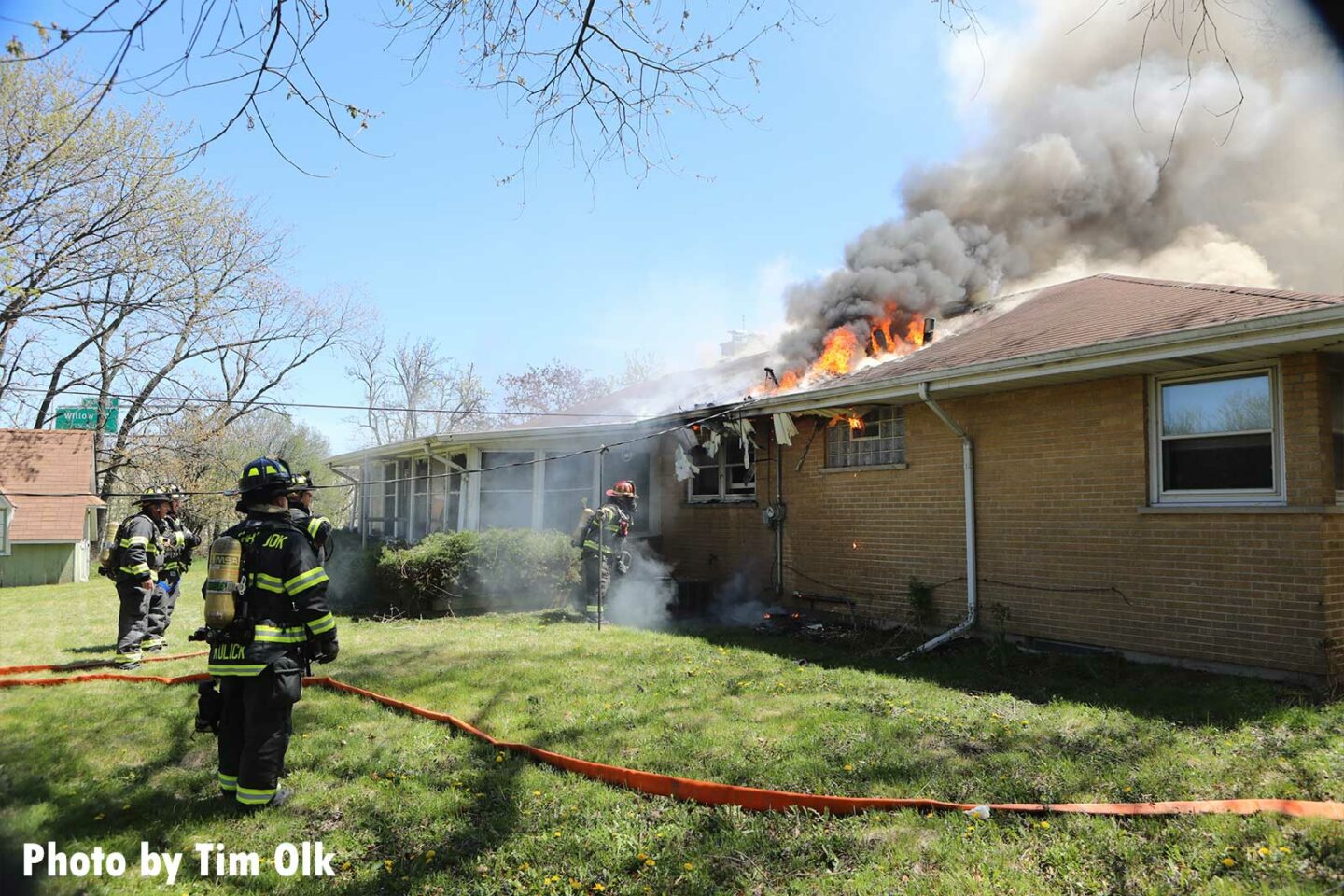 Firefighters move hose at the Northbrook house fire