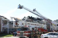 Fire apparatus and tower ladders at apartment fire