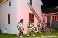 Firefighters at a ladder at the fire scene