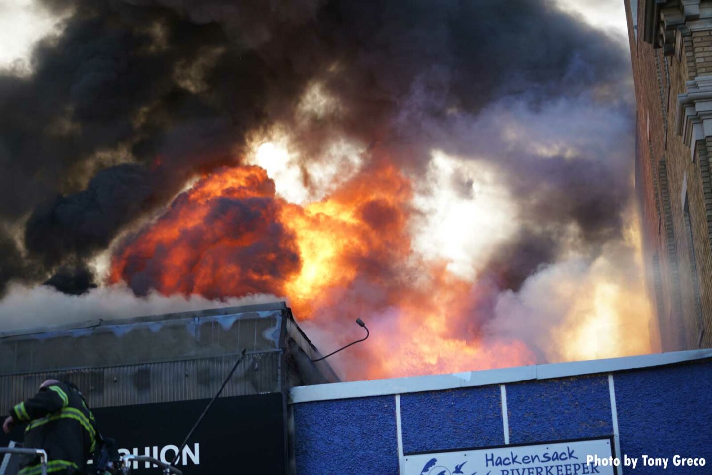 Massive flames shoot through the roof of the building in Hackensack