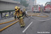 Firefighter hauls hoselines at explosion in downtown Los Angeles