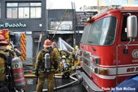 Firefighters using multiple hoselines at Boyd Street blast and fire scene