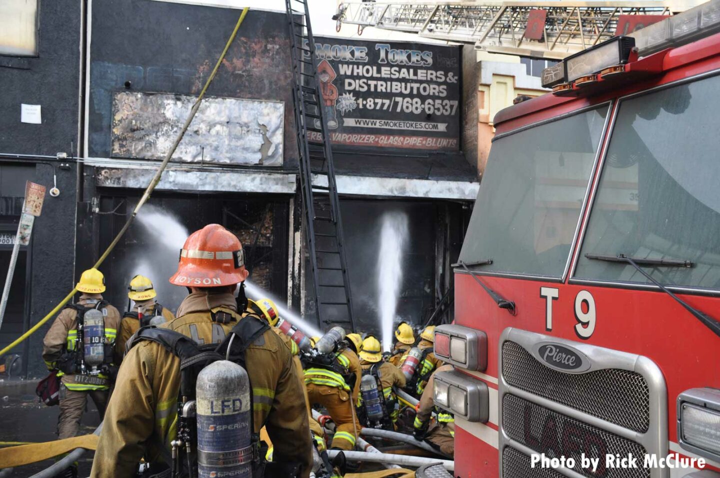 Firefighters spray water into the building after the blast