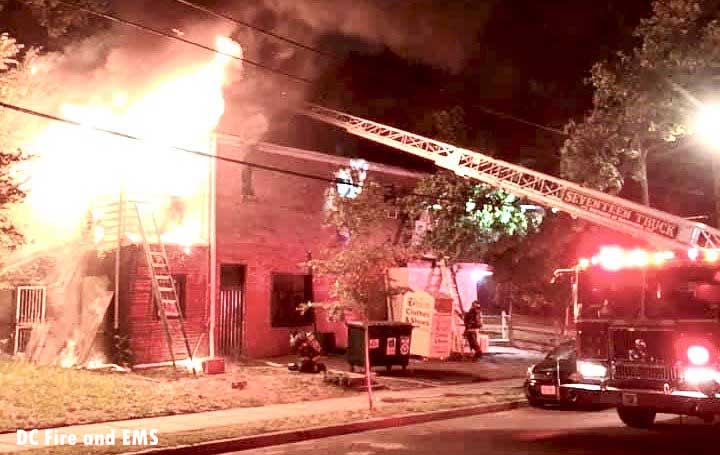 Firefighters working as flames rage in a building in Washington, D.C.