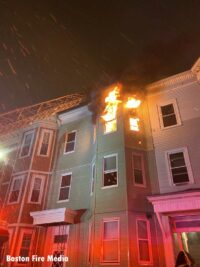 Fire showing from the upper floor of an attached building