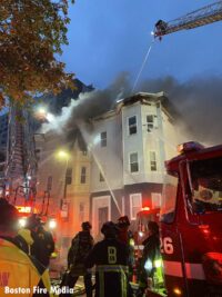 Boston firefighters and emergency workers at the fire scene