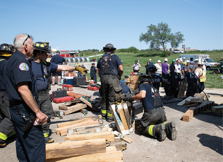 Crews work on cutting additional cribbing for rescue efforts.