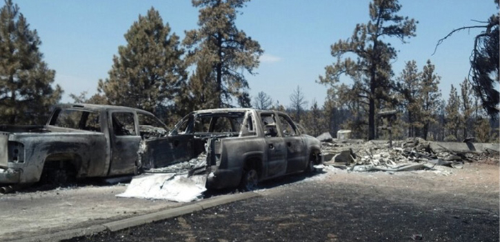 A residence and vehicles destroyed in a fast-moving WUI fire. Firefighters were unable to provide protection because they were unable to remain there safely.