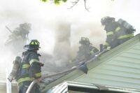 Firefighters performing vertical ventilation