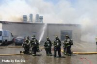 Firefighters conduct stream on exterior of building