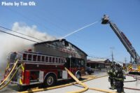 Exterior master stream via tower ladder being used on a large building