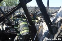 Firefighters work in the debris of a building following a fire