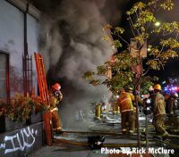 Heavy smoke as LAFD firefighters work at fire scene