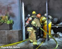 LAFD firefighters advance hose into building