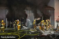 Smoke pours from building as LAFD firefighters battle structure fire