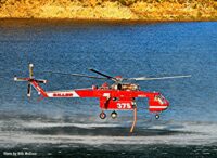 Helicopter gathering water for drop