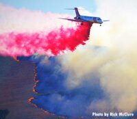 Air tanker drops fire retardant on smoky fire