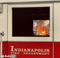 Flames seen through the window of a fire truck