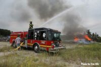 Firefighters use a master stream to put water on the fire