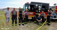 Firefighters in front of a fire truck