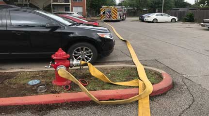 Multiple lines run into a fire hydrant