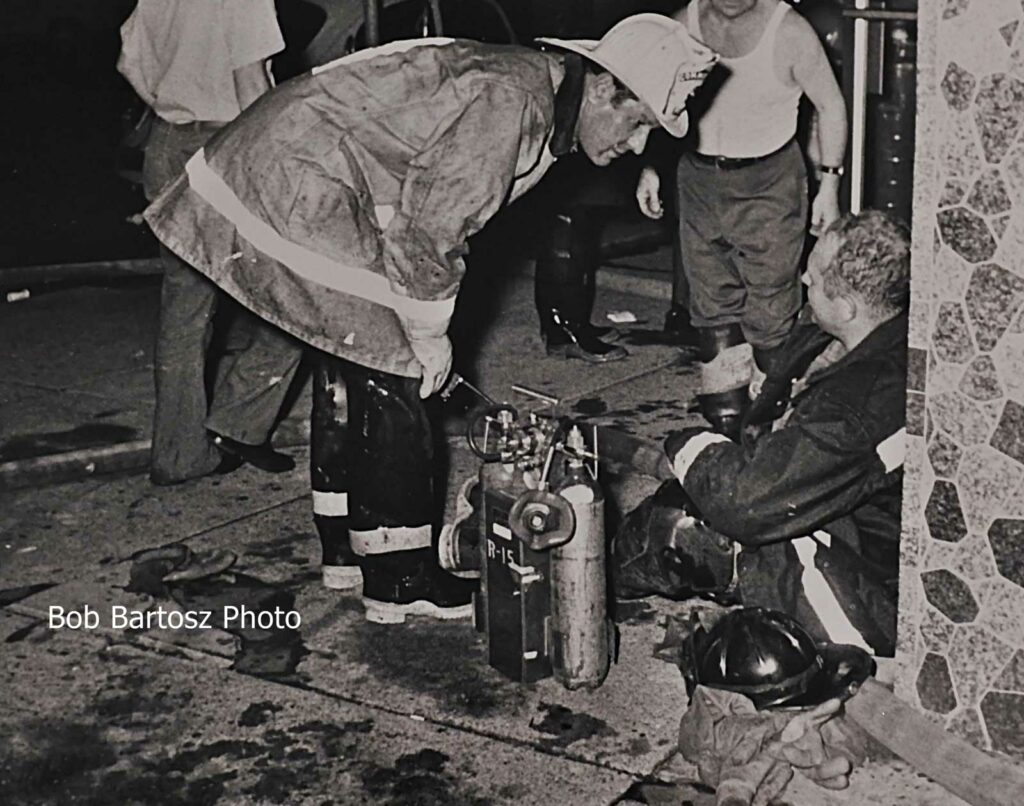 Philadelphia Fire Commissioner Joe Rizzo talks to firefighter who was injured at a four-alarm hotel fire in August 1972