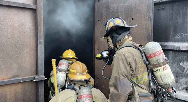 A fire officer leads his crew during a training evolution for realistic training to assess their performance as a team and ensure crew cohesiveness.