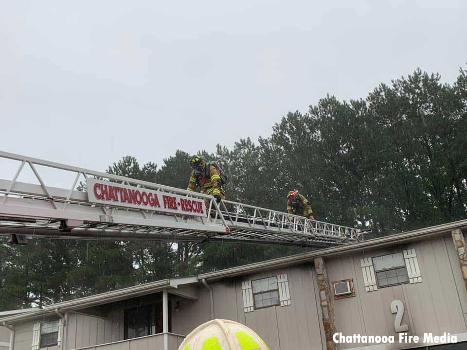 Firefighters descend from the roof on an aerial