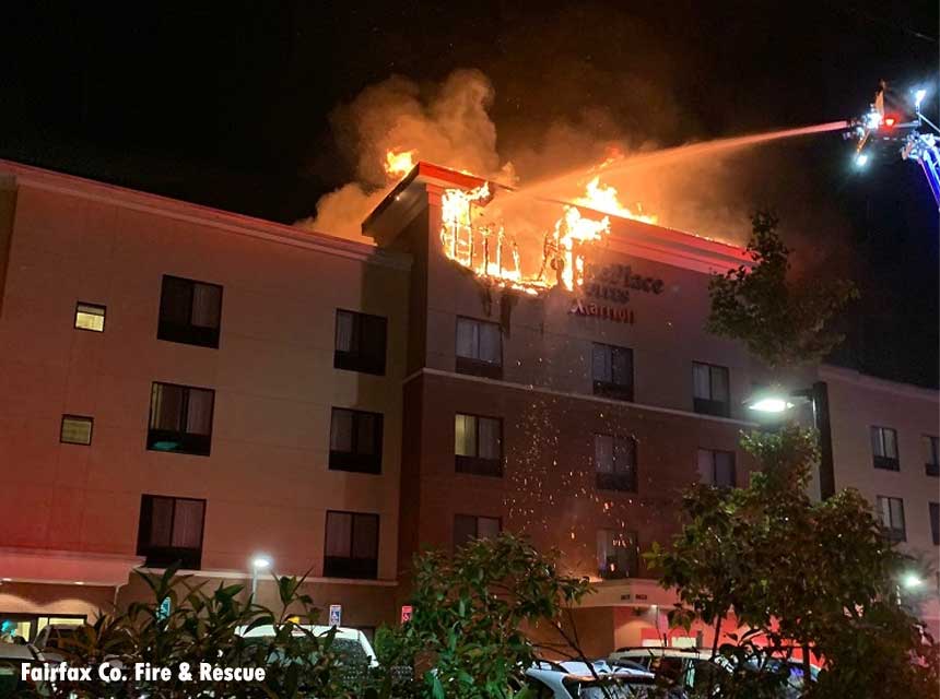 Tower ladder stream aimed on roof fire at hotel