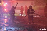 Indianapolis firefighters manage a hoseline