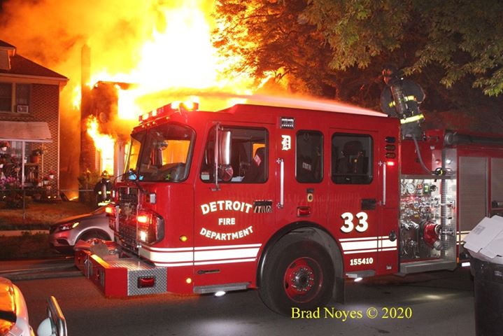 Detroit fire truck with flames behind it