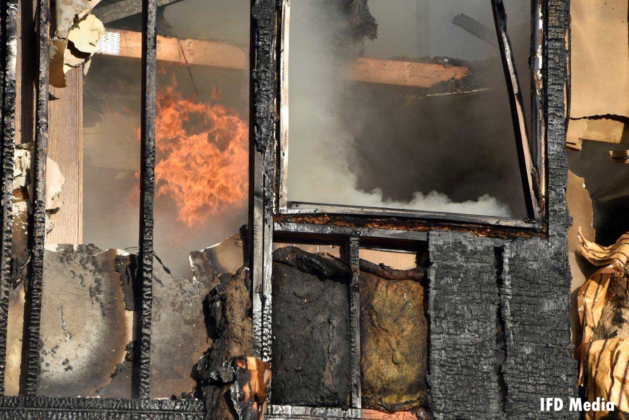 Flames inside the burned-out structure