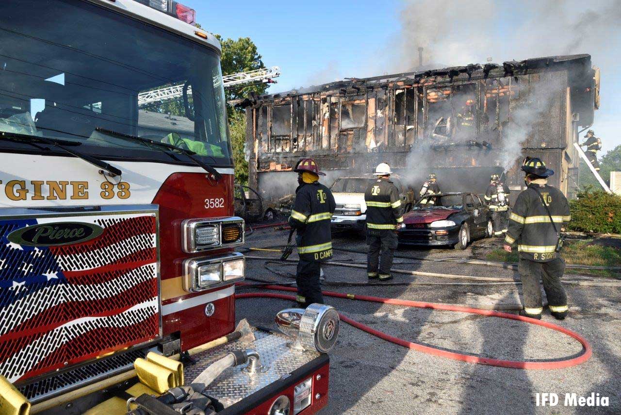 Fire trucks and firefighters at the scene of the deadly fire in Indiana